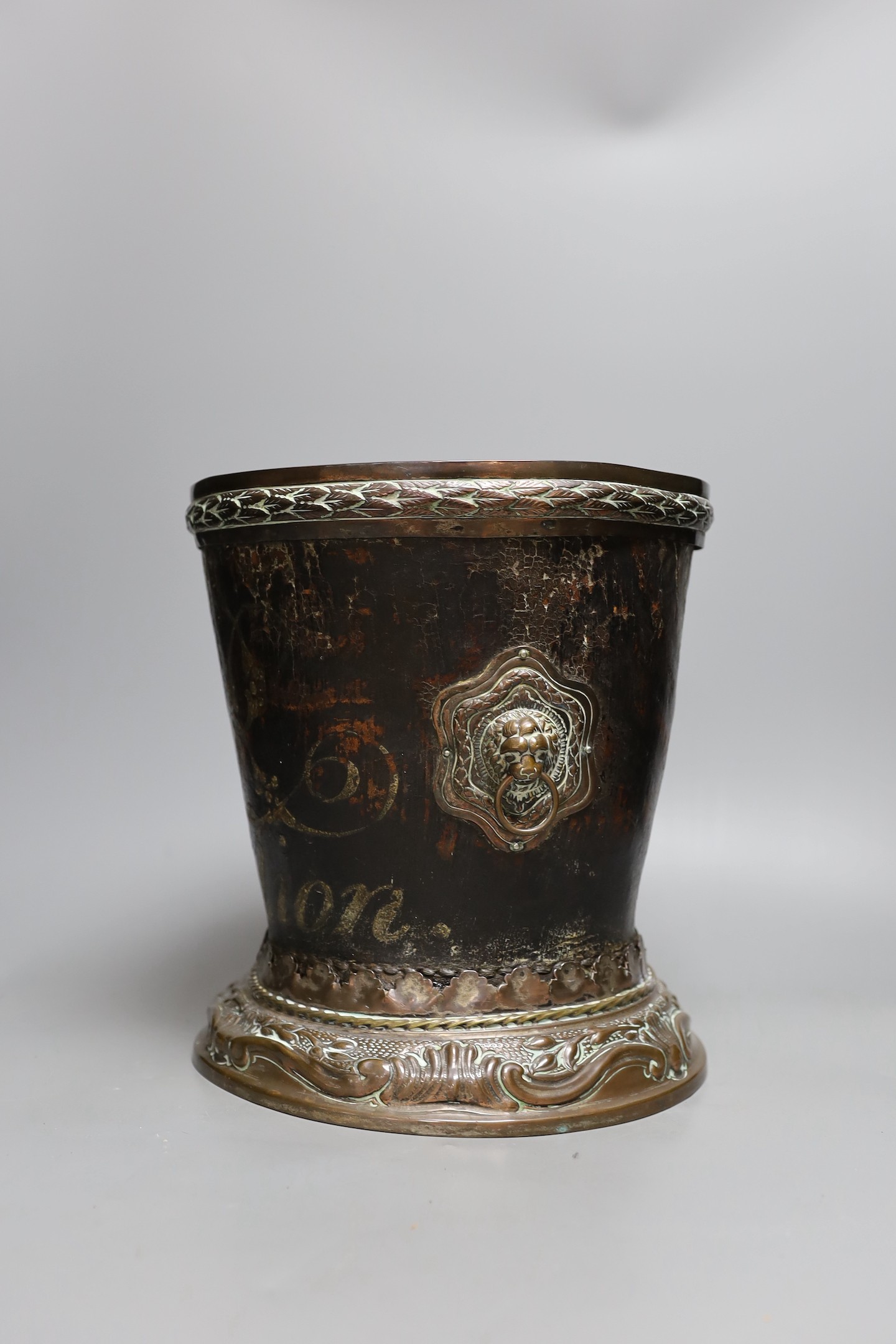 A George III leather fire bucket dated 1800, with later 19th century mounts, inscribed 'GR 1800 Pavilion' (cut down), 27cm tall